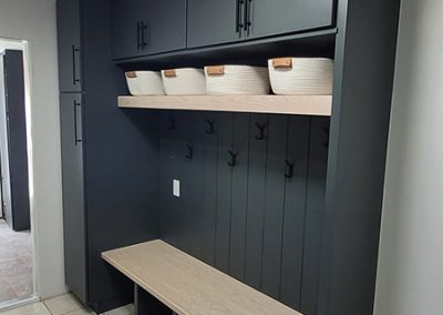new navy drop zone with wood benches and woven baskets above hooks