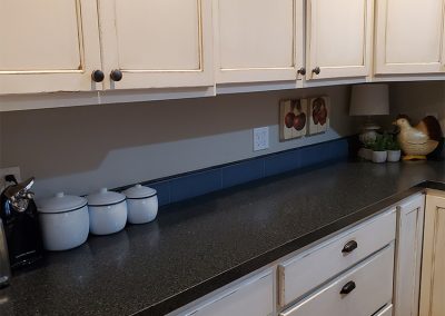 Freshly painted kitchen cabinets with Black countertop